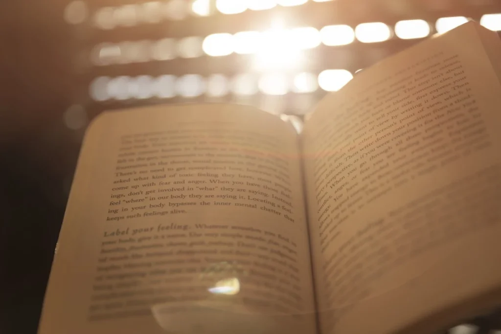 Open book bathed in warm golden light representing the power of reading to change habits