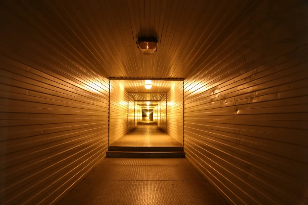 Warmly lit corridor stretching into the distance representing the path forward after quitting