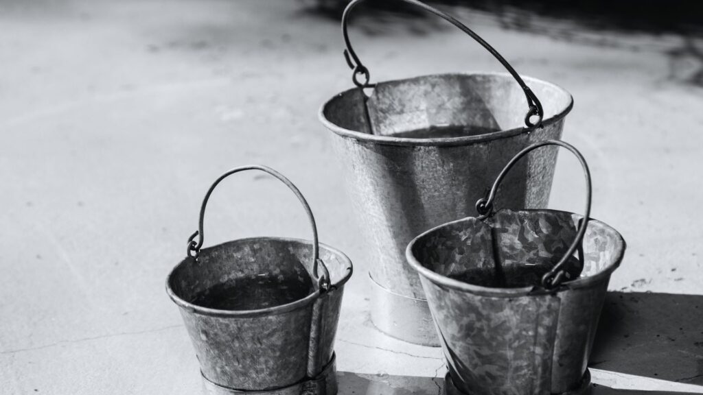 An image of 3 steal buckets on a plain background to illustrate a better way to define stress.