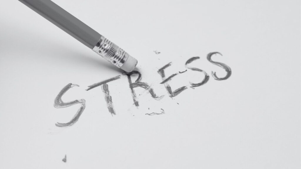 the word stress on a paper with a pencil eraser to illustrate how this tiny tactic can reduce stress fast.