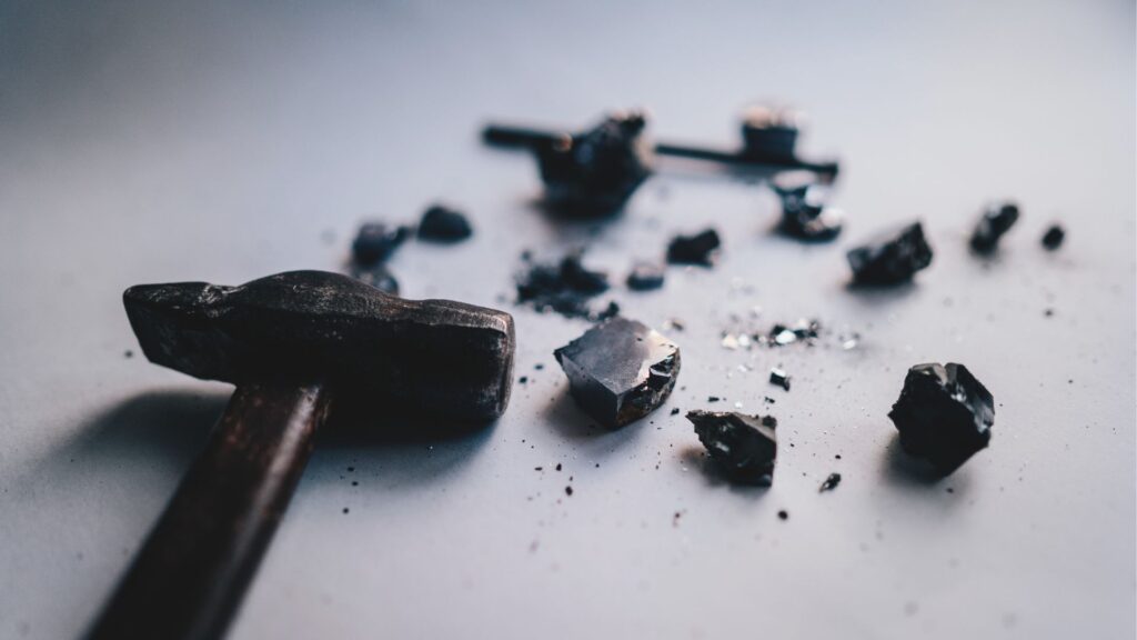 a hammer has crumbled a rock.