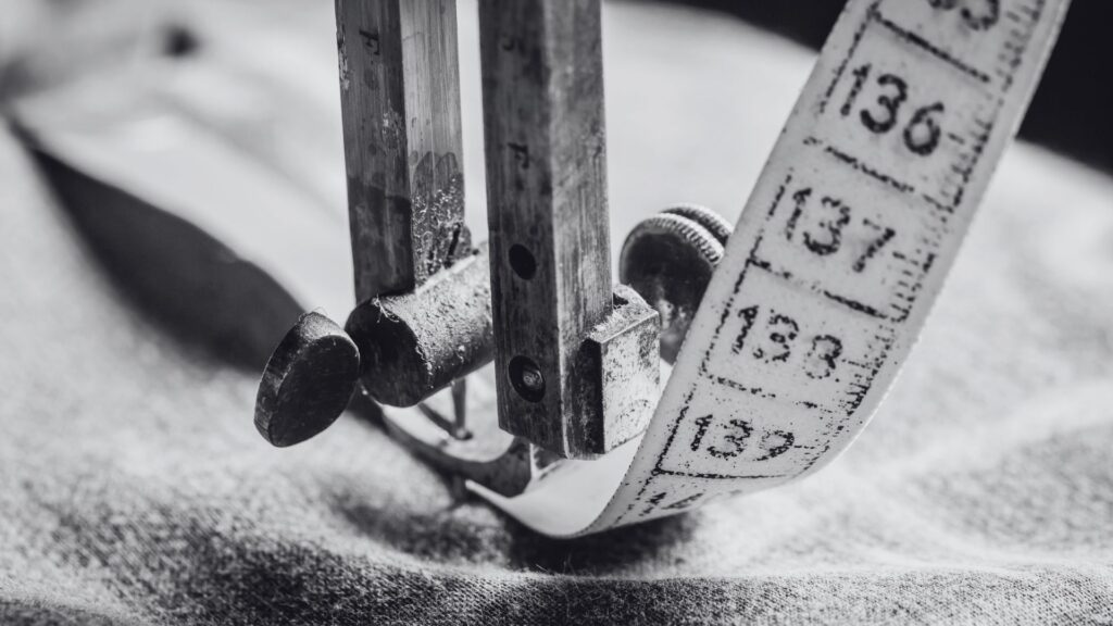 an antique sewing machine sewing a measuring tape to illustrate the concept of measuring stress in a stress test