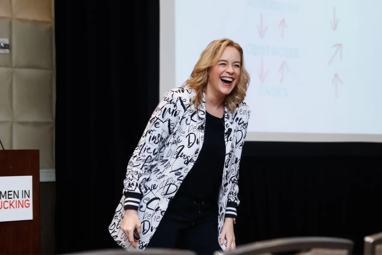 Allison Graham laughing on stage during keynote